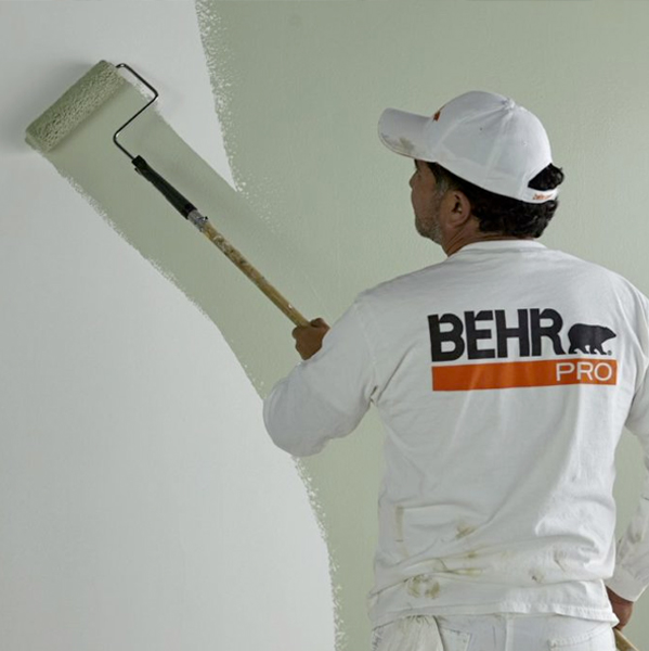Behr Pro contractor painting a wall green