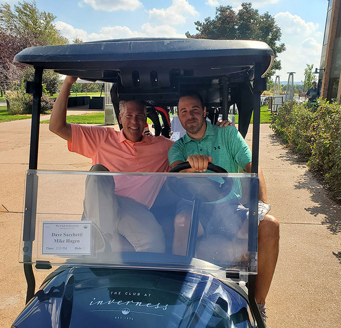 Mike Hagen of Rinnai with Dave Sacchetti of HomeSphere in golf cart