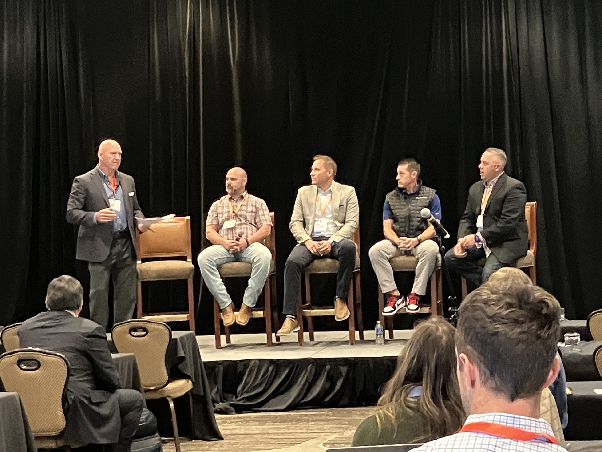 Five people sit on a stage as they discuss home building in 2023.