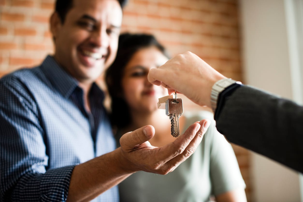 Couple receiving the keys to their new home